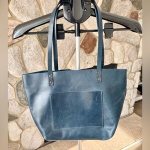 Deep Teal leather tote
It’s new but it has some marks and scratches